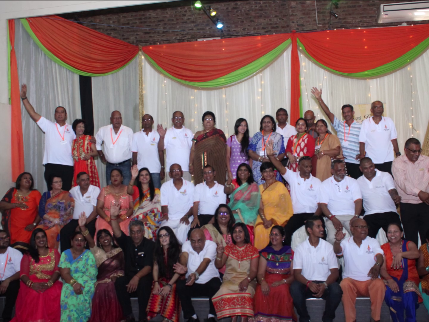 The full Jyoti Jivanam volunteer team celebrating together in a decorated hall